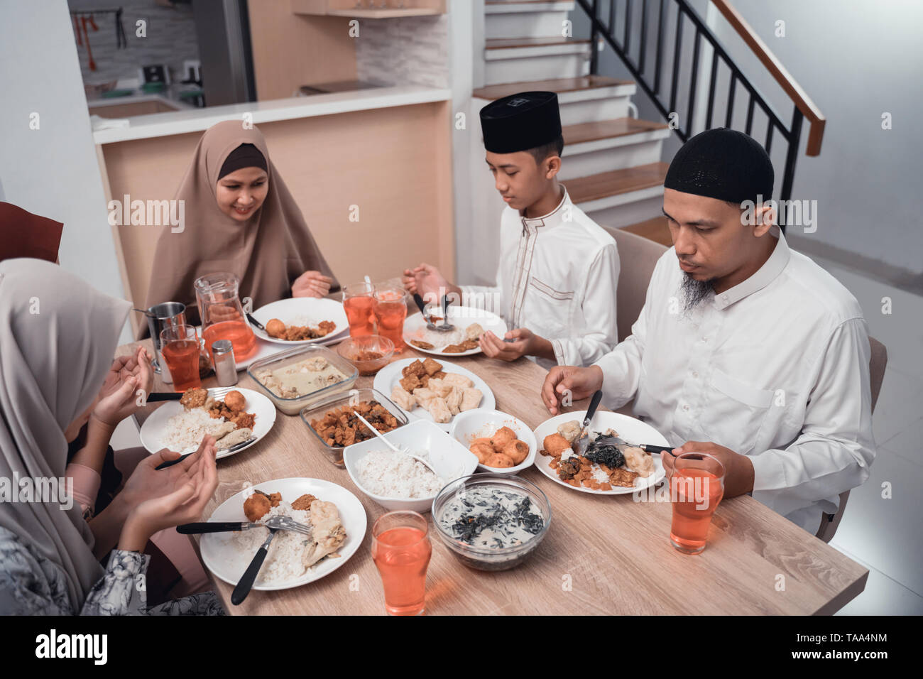 muslim family together pray before meals, a fast breaking meal ...