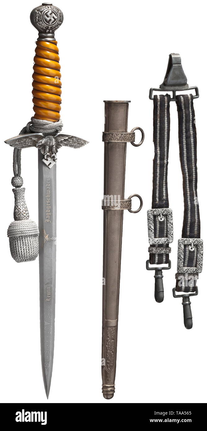 A replica of an honour-dagger for a Luftwaffe officer Complete with hanger and sword knot. Damascus blade bearing an eagle with remnants of gilding and the partially ground off dedication, 'Leutnant...Jagdgeschwader' (tr. 'Lieutenant...Fighter Squadron'), 'Mit herzlichsten Glückwunschen zur Ritterkreuz-Verleihung' (tr. 'With cordial congratulations on the award of the Knight's Cross'). Made by 'Eickhorn Solingen'. Aluminium quillons and pommel, yellow plastic grip with wire winding. Silver-plated, iron scabbard. Length 39 cm. historic, historical, melee weapon, melee weapon, Editorial-Use-Only Stock Photo