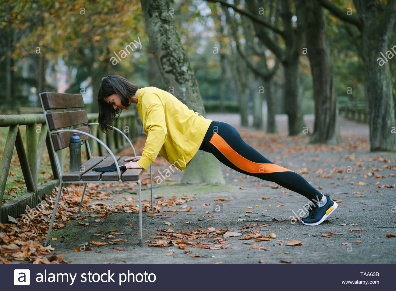 Female Athlete Doing Bench Push Ups For Strength Workout At City