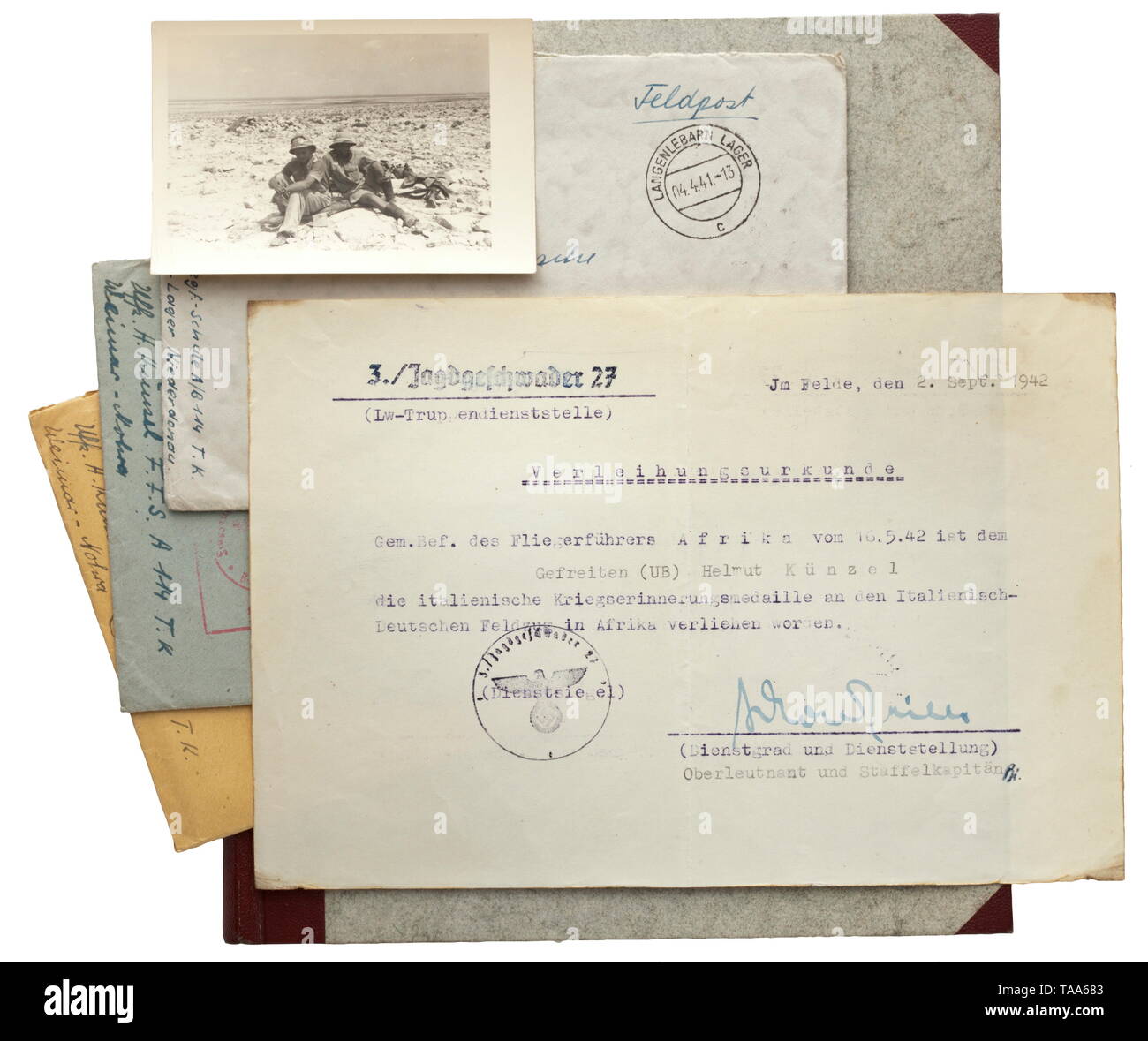 Hans Joachim Marseille - an estate of a squadron comrade Award document for the Italo-German Campaign Medal in Africa with original signature of Marseille as squadron commander of 3./JG 27 to subsequent pilot Künzel. Field post consisting of three letters with envelopes, posted and with stamped imprint. A book 'Mein Freund Marseille', half-leather edition 1944 by Fritz Dettmann, John Jahr Press, Berlin. A photo with inscribed reverse. On the issuance date of the award document (2 September 1942), 'Jochen' Marseille achieved his 126th aerial victory whereupon he became the f, Editorial-Use-Only Stock Photo