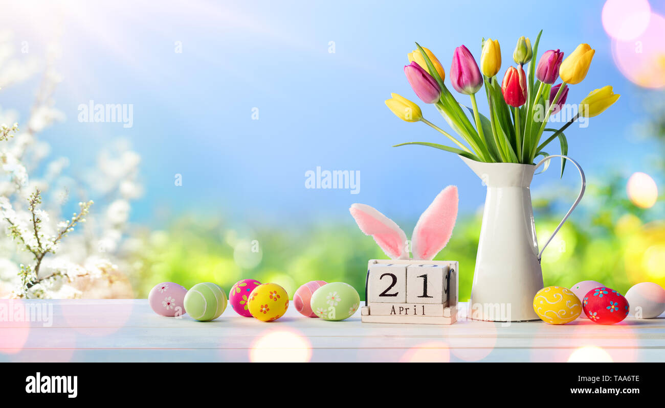 Easter - Calendar Date With Decorated Eggs And Tulips In Sunny Garden Stock Photo