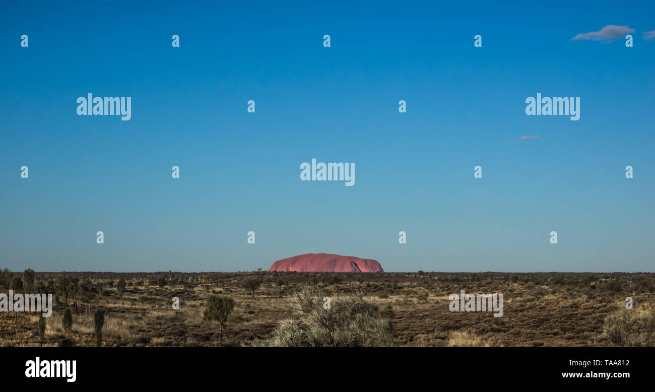Australia's iconic Uluru/Ayers Rock as viewed from a distance across ...