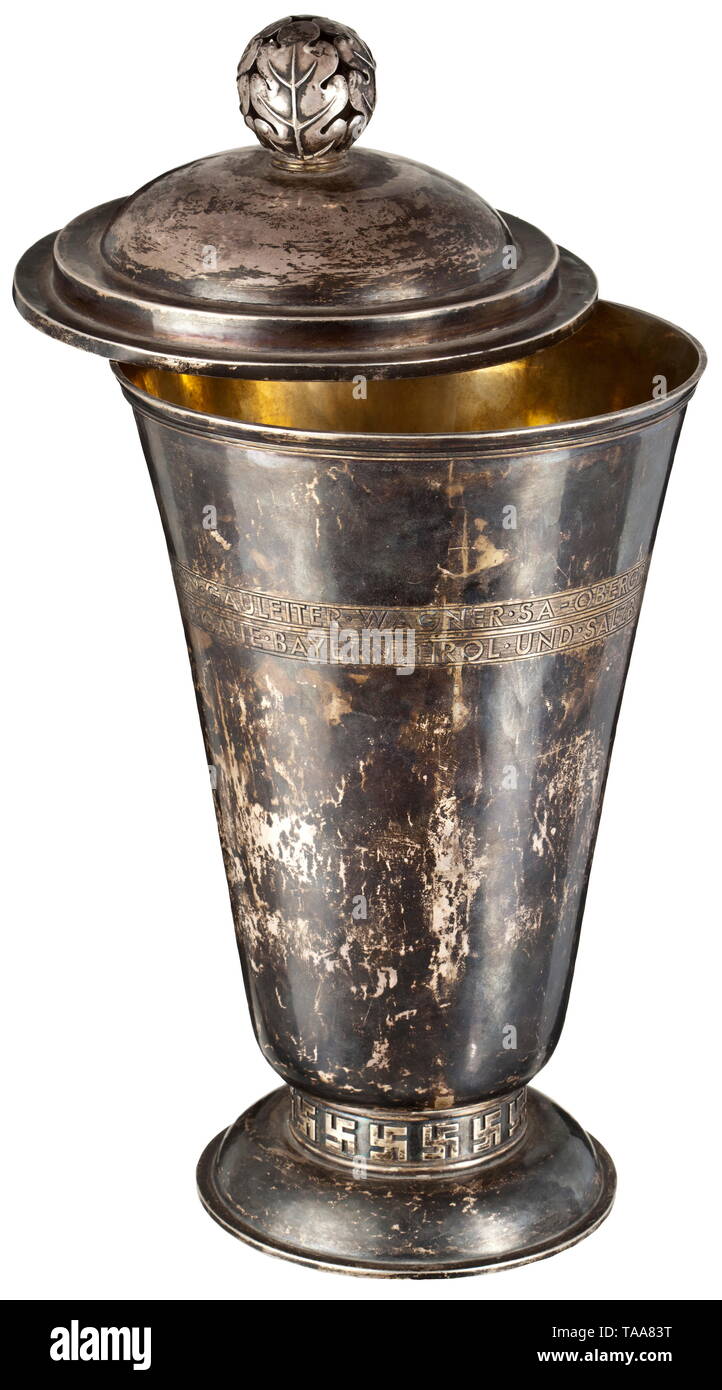 An honour prize from Gauleiter Wagner to the victor in the 'Ranggeln' competition for districts Bavaria, Tyrol and Salzburg Silver, lidded cup with engraved inscription 'Ehrenpreis von Gauleiter Wagner SA-Obergruppenführer für den Sieger im Ranggeln der Gaue Bayern, Tirol und Salzburg in Saalfelden 18.Sept. 1938'. The front side with an applied SA emblem, the edge above the base with a continuous swastika décor, the inside gilt. Underneath are illegible jeweller markings and fineness punches. Height 34 cm. Weight 970 g. 'Ranggeln' are a beloved type of games in the eastern , Editorial-Use-Only Stock Photo