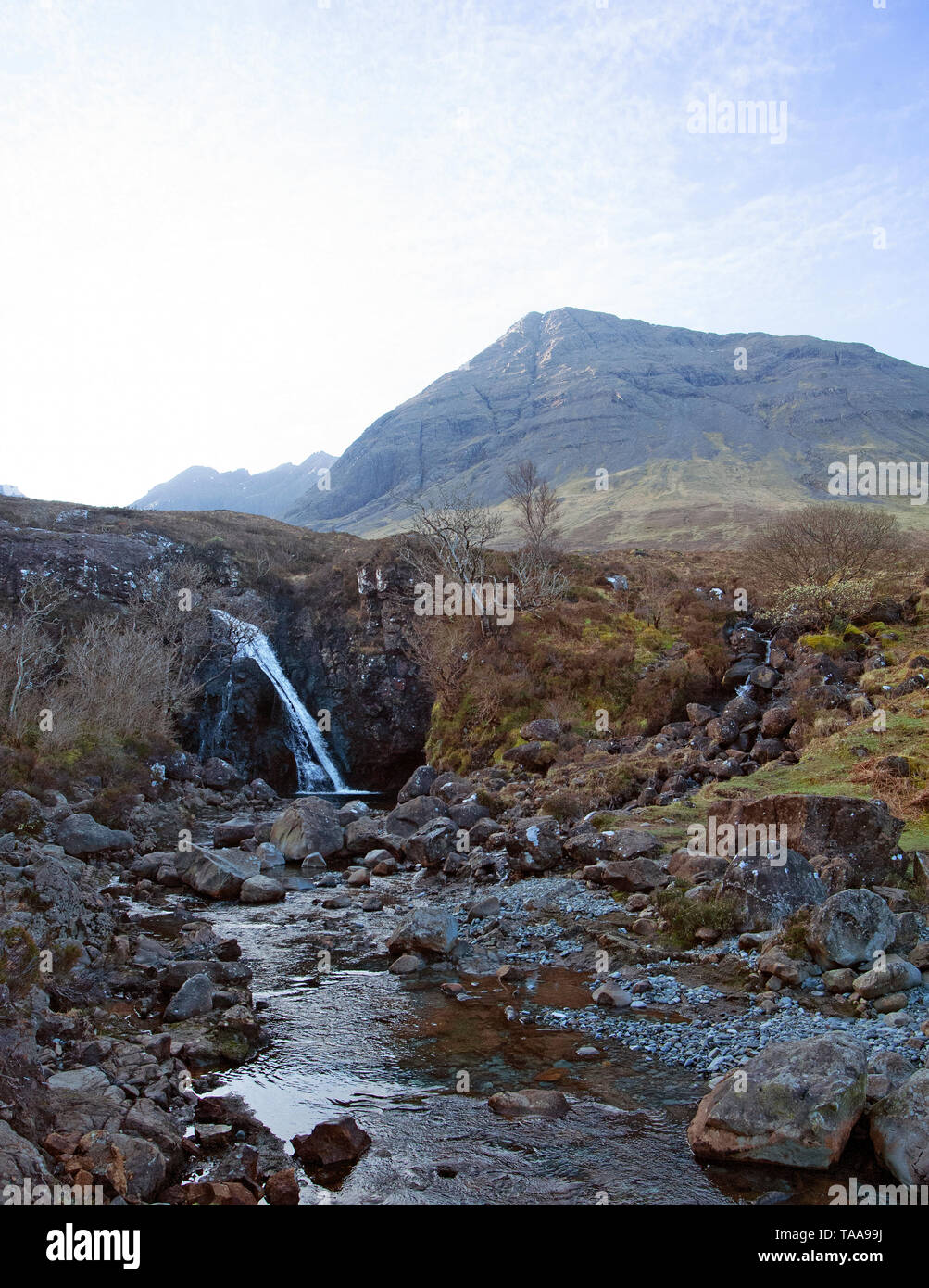 A Fairy Pool and waterfall along the River Brittle which flows along Glen Brittle on the Isle of Syke, Scotland. In the distance is Bruach na Frithe. Stock Photo