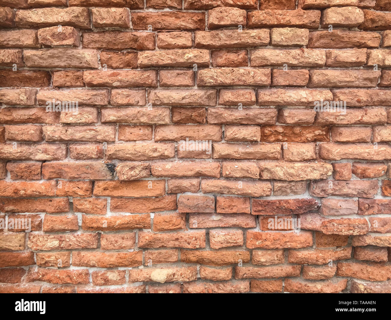 Weathered red brick wall texture, rustic background, Venice, Italy, rough masonry surface Stock Photo