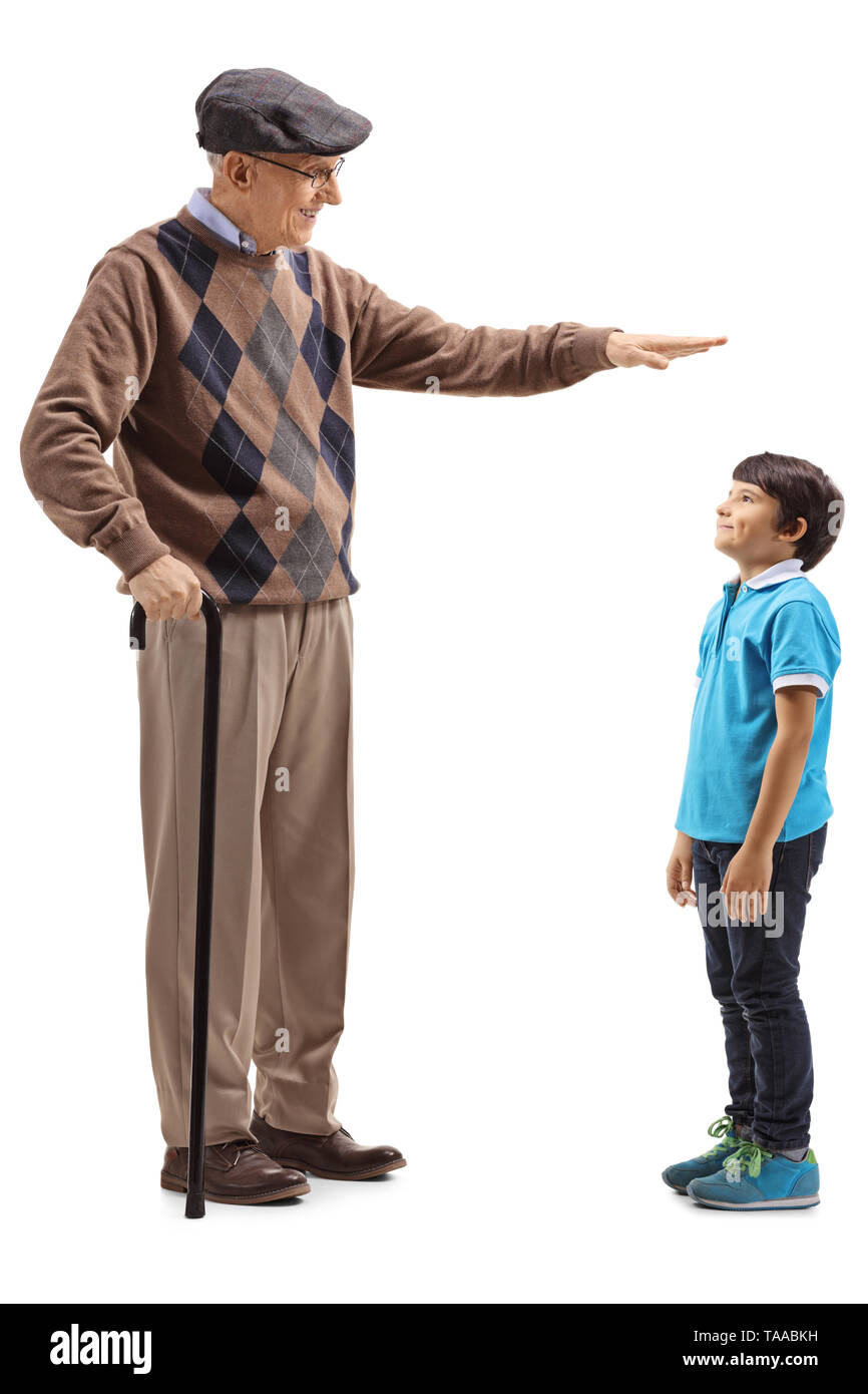 Full length shot of a grandfather showing the height of his grandson isolated on white background Stock Photo