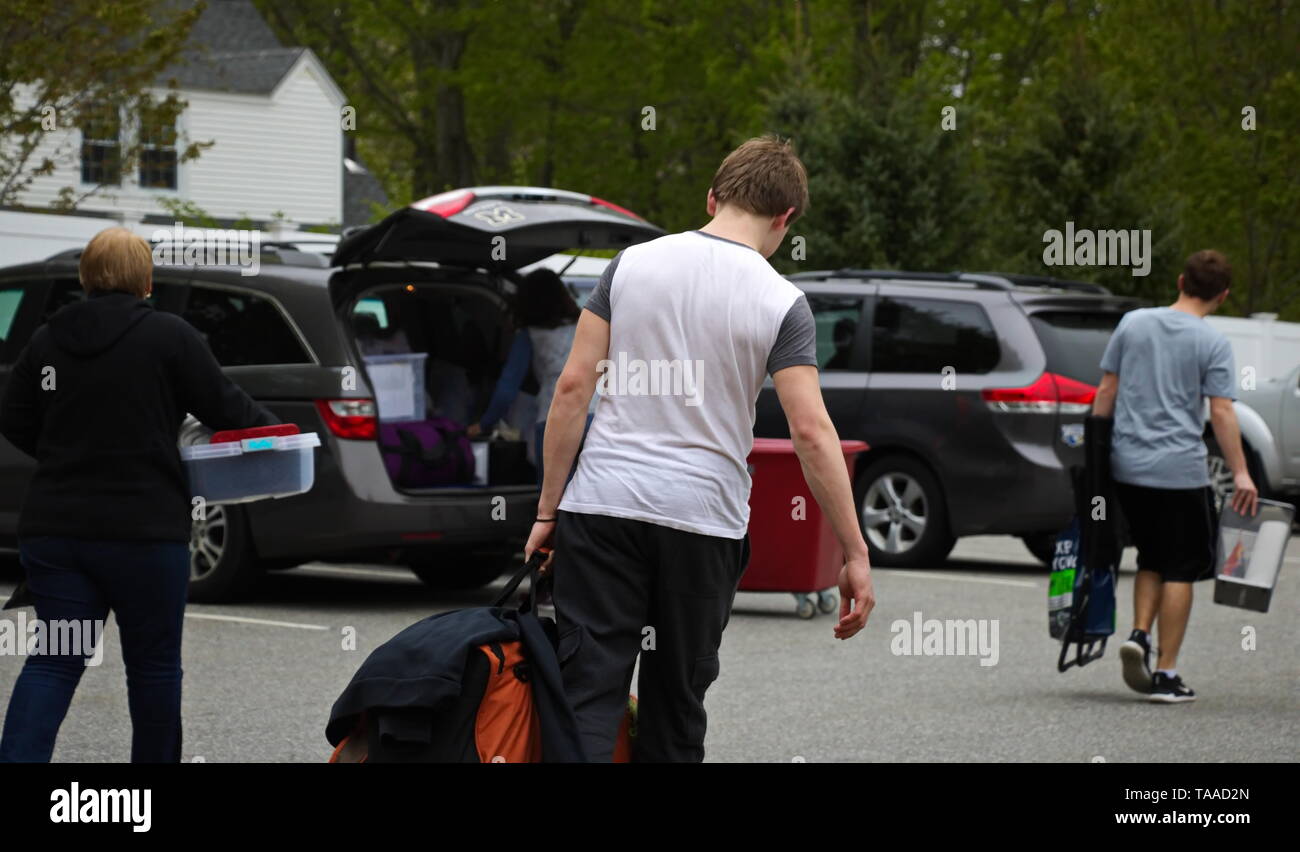Storrs, CT / USA - May 10, 2019: A freshman moves out of the dorms accompanied by his brother and mother Stock Photo
