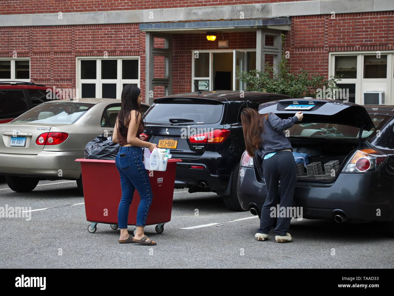 Storrs, CT / USA - May 10, 2019: A freshman moves out of the dorms with help from her friend Stock Photo