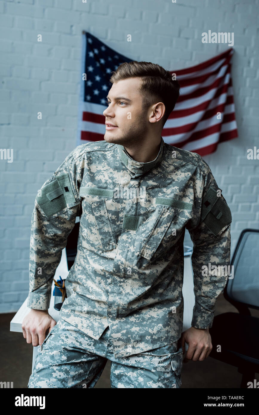 handsome man in military uniform standing in office near american flag  Stock Photo - Alamy