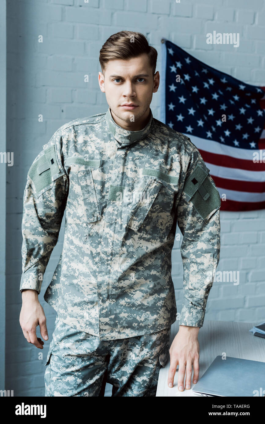 handsome man in military uniform standing near table in office Stock Photo  - Alamy