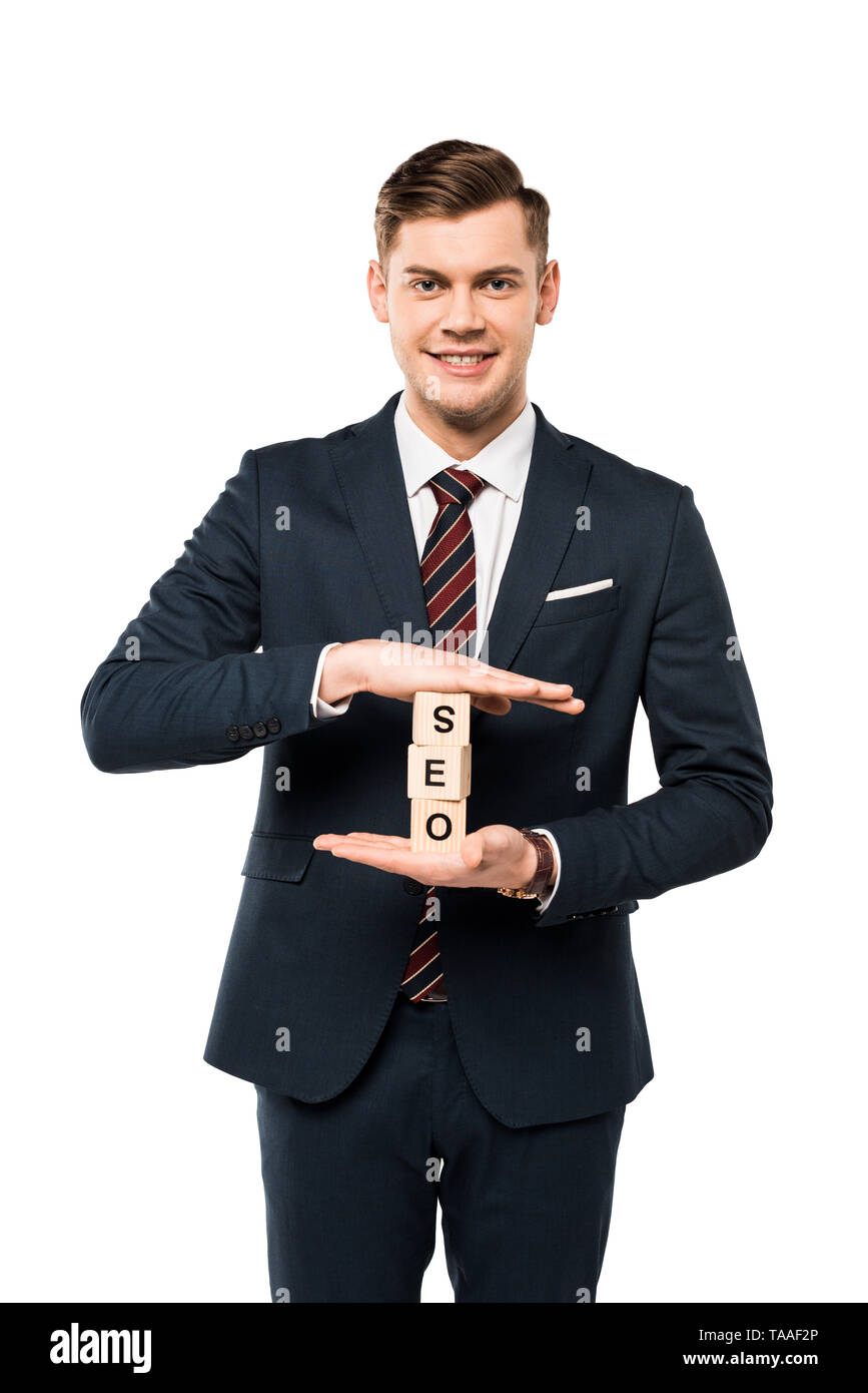 happy businessman holding wooden cubes with seo lettering isolated on white Stock Photo