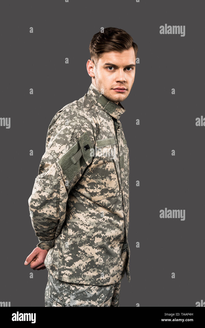 handsome soldier looking at camera isolated on grey Stock Photo - Alamy