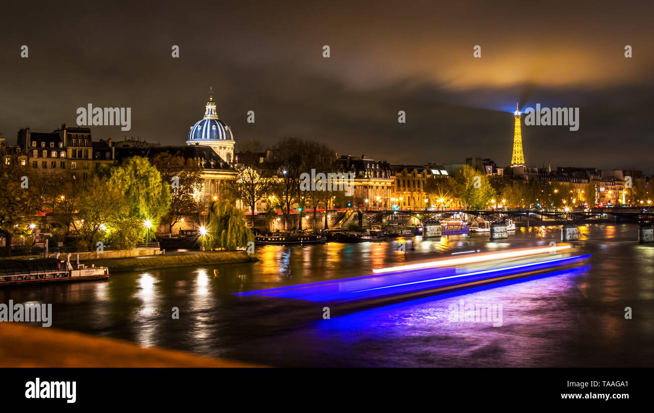 Night cityscape scene in Paris over the Seine river with the Eiffel ...