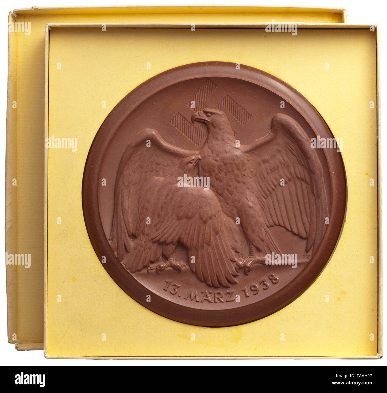 Gauleiter Martin Mutschmann - a plaque in its case Böttger stoneware from the Meissen Porcelain Manufactory. National eagle with swastika, date (tr.) '13 March 1938' (Annexation of Austria) on the obverse. On the reverse NS motto and dedication in gold 'Für treue Pflichterfüllung als Ortsgruppenleiter in Leipzig Gautag 1938' (tr. 'For loyal duty as Local Group Leader in Leipzig Gautag 1938'), swastika and Meissen mark of crossed swords. Diameter 12 cm. In the original cardboard case, slightly knocked, one corner torn. Very rare. Mutschmann, Gauleiter of Saxony, was executed, Editorial-Use-Only Stock Photo