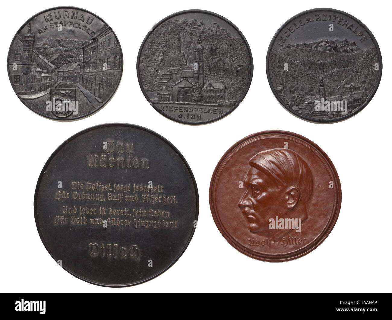 Mountain troops of the Waffen-SS - five Bakelite plaques Three plaques with inscription (tr.) 'SS Sign up voluntarily for the mountain troops of the Waffen-SS', views of Murnau, Inzell and Kiefersfelden on the reverse, diameter of each circa 40 mm. Furthermore, a brown plaque inscribed (tr.) 'SS Leibstandarte-SS Adolf Hitler enlistment at the age of 17', the reverse with a portrait of Hitler, diameter 45 mm. Plaque (tr.) 'Day of the German police force - 14-15 February 1942', Gau Kärnten Villach on the reverse, diameter 55 mm. Slight traces of age. historic, historical, 20t, Editorial-Use-Only Stock Photo