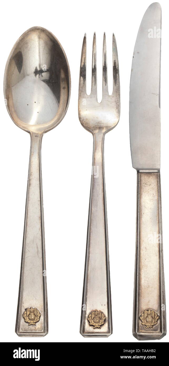 Joachim von Ribbentropp (1893 - 1946), Reich Minister for Foreign Affairs - a three-piece cutlery set from the ministry Pieces of silver cutlery, stamped with crown, crescent and '900'. Applied symbol of the Foreign Office, national eagle with swastika above globe. Knife with iron blade, length 21.3 cm, spoon and fork 18.5 cm each. Slight traces of age and usage. Rare. historic, historical, 20th century, 1930s, NS, National Socialism, Nazism, Third Reich, German Reich, Germany, German, National Socialist, Nazi, Nazi period, fascism, Editorial-Use-Only Stock Photo