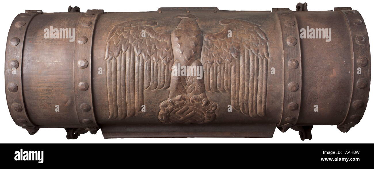 An ancestral chest, circa 1938 Elaborately forged iron chest, the domed hinged lid with large national eagle, on the reverse the symbol of the Reichsnährstand, the obverse with a coloured, enamelled coat of arms, on each side the Odal rune, the last rune of the Elder Futhark, with the reconstructed Germanic meaning of landed property. Handles, two locks (without keys, damaged, one keyhole cover enclosed but unattached). The interior lined with wood (water damage). Signs of age and usage. Dimensions circa 75 x 30 x 32 cm. Presumably the master work of a wrought iron craftsma, Editorial-Use-Only Stock Photo