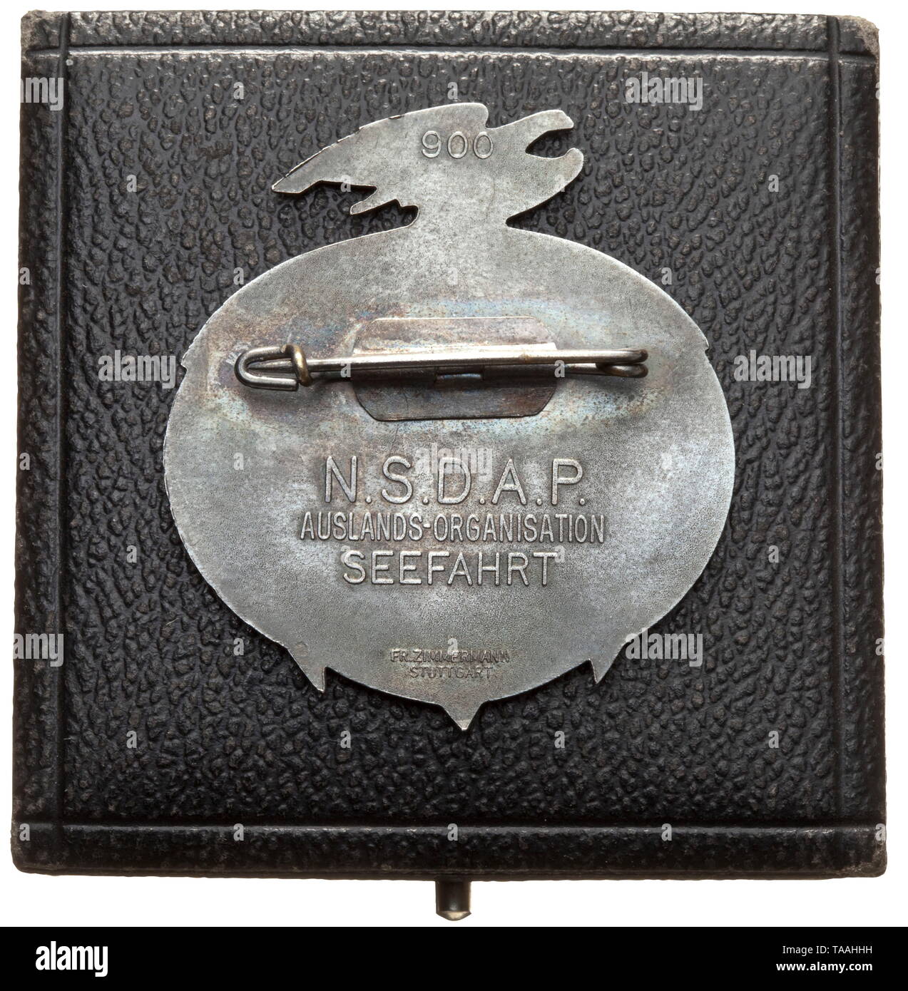 A badge for guests of honour 'Seefahrt ist Not' in a case Pin badge with sailing ship above anchor, national eagle with swastika. Motto 'Seefahrt ist Not - Tag der deutschen Seefahrt 25.-26.5.1935'. (tr. 'Navigation is necessary - Day of German Navigation 25 -26 May 1935'). On the reverse horizontal attachment pin and mark '900' as well as inscription 'N.S.D.A.P - Auslands-Organisation Seefahrt', manufacturer's mark 'Fr. Zimmermann Pforzheim'. In a matching presentation case. Dimensions of case 6 x 6.5 cm. Rare. historic, historical, awards, award, German Reich, Third Reich, Editorial-Use-Only Stock Photo