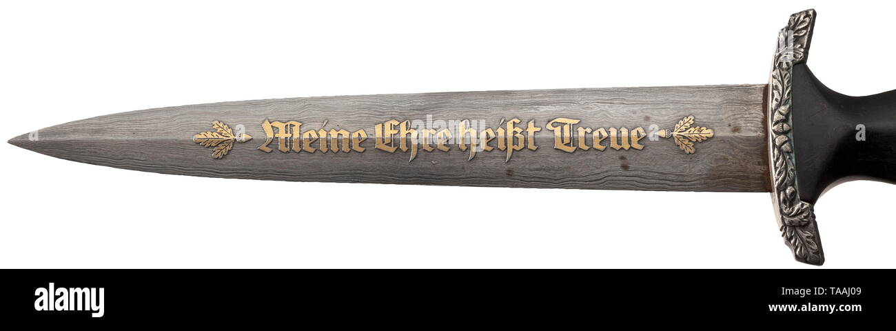 An SS honour dagger with Damascus blade, Eickhorn, Solingen Damascus blade with high-etched, gilded motto 'Meine Ehre heißt Treue' between oak leaf branches. On reverse side high-etched maker's logo. Silver grip mountings with oak leaf décor in relief, black wooden grip with nickel-silver national eagle and enamelled SS emblem. Steel scabbard with original, black leather cover (minimal abrasions) and silver-plated scabbard mountings. Short black leather hanger with belt loop for attaching to coat. Length 37 cm. Extremely rare, only light signs of usage and age. historic, hi, Editorial-Use-Only Stock Photo
