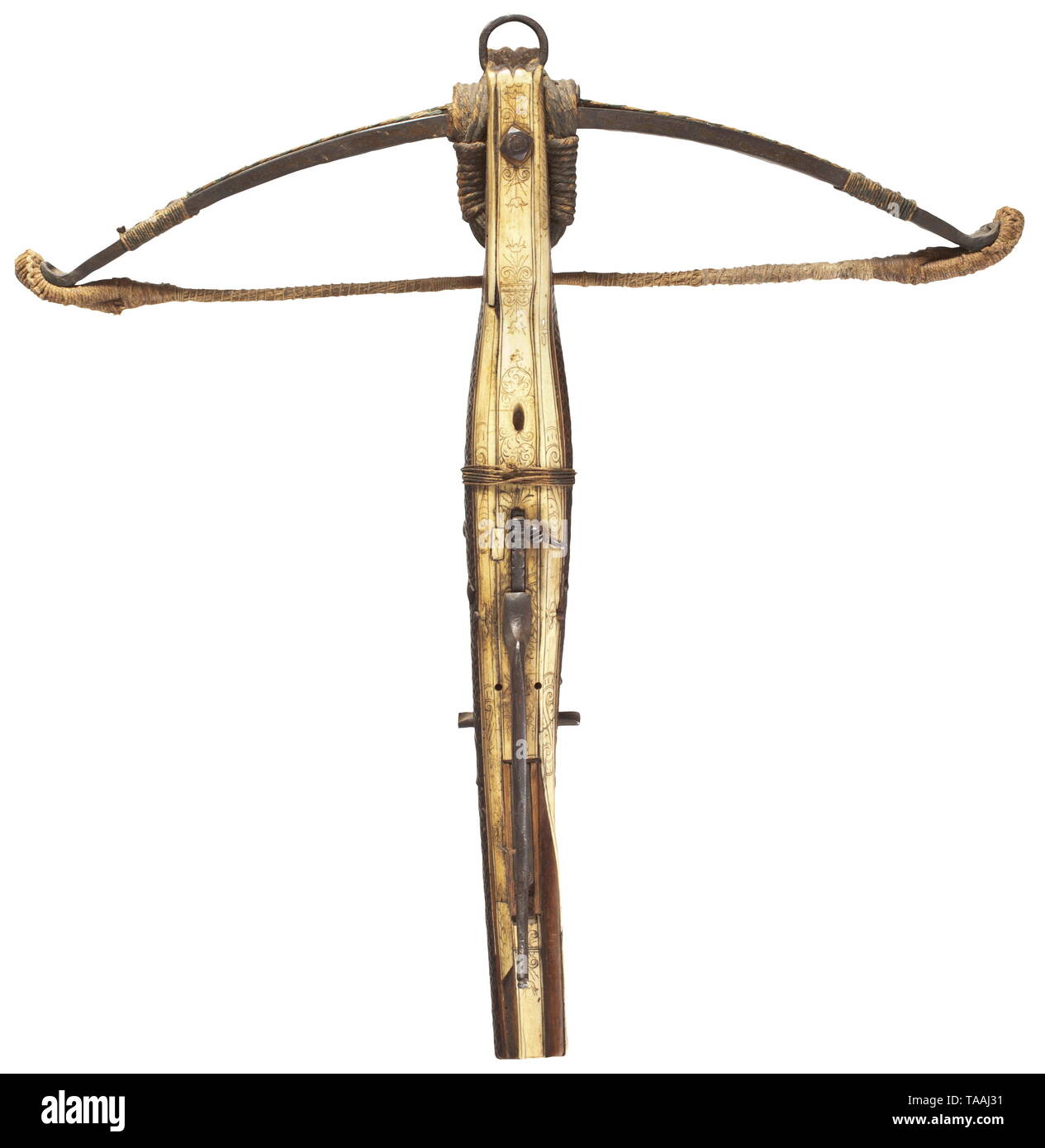 A German hunting target crossbow, circa 1600 Sturdy iron prod with braided hemp string and remnants of the original tassels. Retained by cords with an interlaced iron suspension ring. Slightly bellied tiller made of walnut, the top and bottom veneered with engraved bone inlays, the sides with ornamentally carved scales. The quarrel groove is missing, the bone nut secured with cord, iron studs to support the cranequin. Iron trigger guard, the trigger system modified while the weapon was in use, the trigger mechanism with set trigger, probably 18th, Additional-Rights-Clearance-Info-Not-Available Stock Photo