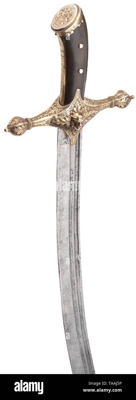 A superb silver-mounted sabre for a Hungarian magnate, circa 1870/80 Old, slightly curved, single-edged blade dating from the 17th century, with a broad, double-edged point. Double fullers on both sides, the root with a pseudo inscription and a Turkish mark (tughra?) stamped into one side. The quillons with relief décor in richly engraved and chased gilt silver, one arm cracked and stabilised. On the front, the head of a Magyar prince in half relief. Grip panels of dark horn with finely engraved grip bands, the pommel cap with an integrated, deli, Additional-Rights-Clearance-Info-Not-Available Stock Photo