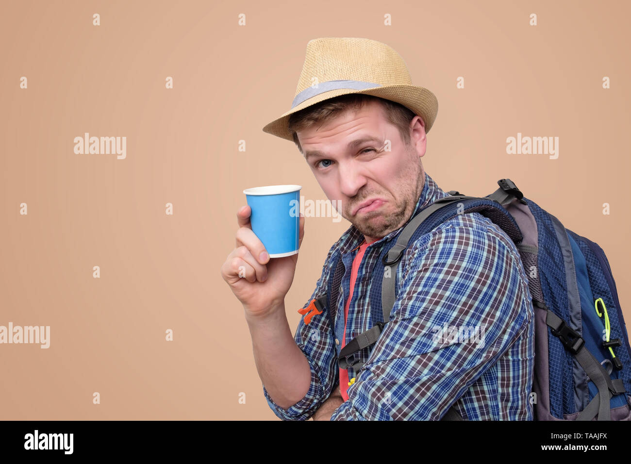 Young man wearing summer hat and holding cup Stock Photo