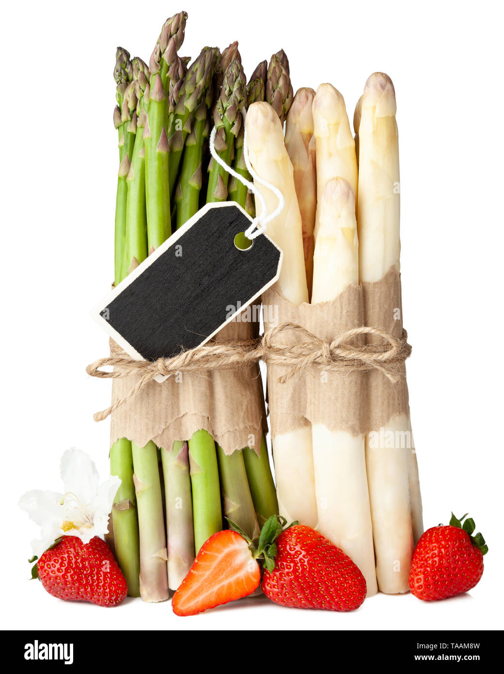 Fresh green and white asparagus with strawberries on isolated white background Stock Photo