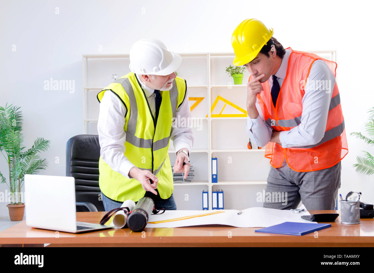 Two engineers colleagues working under project Stock Photo - Alamy