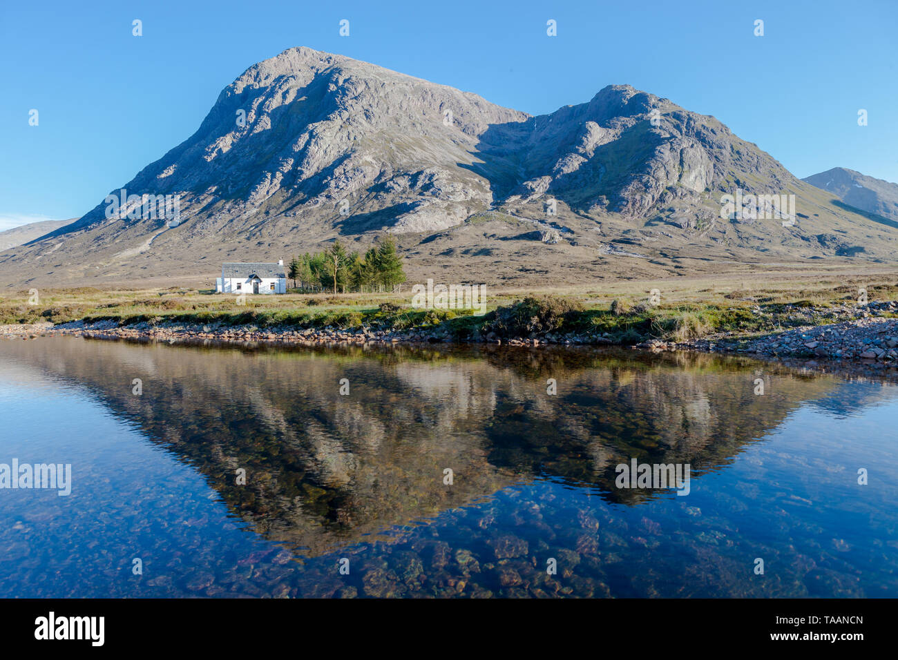 Cottage With Reflection In The Shadow Of A Hill In Early Evening Glen Coe Scotland Stock Photo Alamy