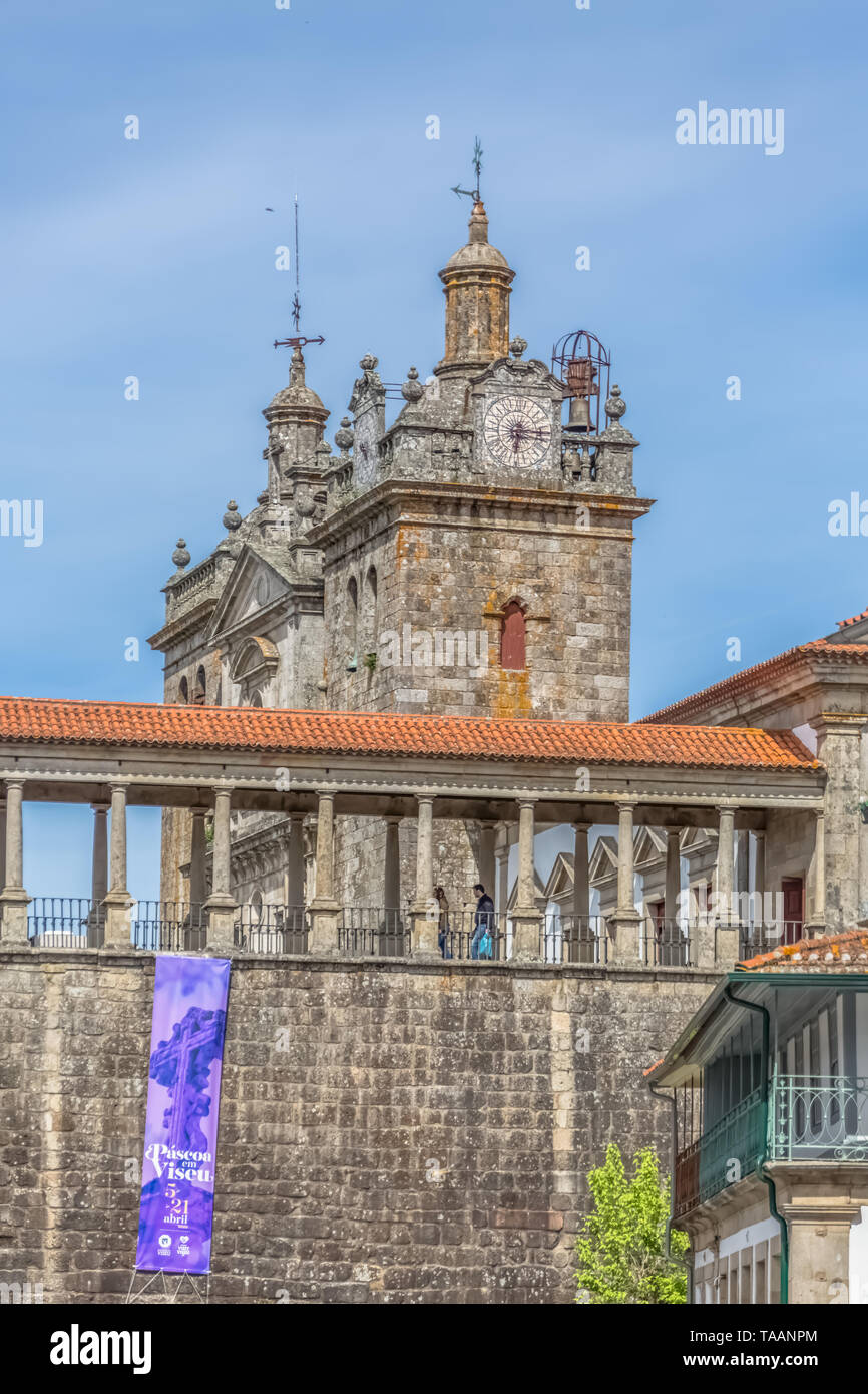 Viseu / Portugal - 04 16 2019 : Detailed view at the lateral facade of the Cathedral of Viseu, Sé Cathedral de Viseu, column gallery with a couple, ar Stock Photo