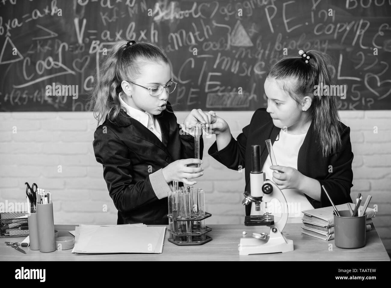 Make studying chemistry interesting educational experiment concept microscope and test tubes on table