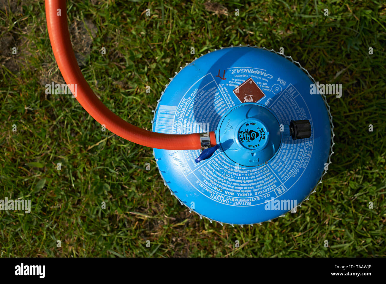Gas cooker and cooker next to a tent of a camping site in nature Stock