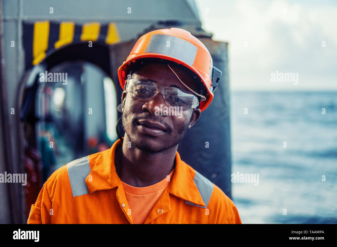 Tired Seaman AB or Bosun on deck of vessel or ship Stock Photo