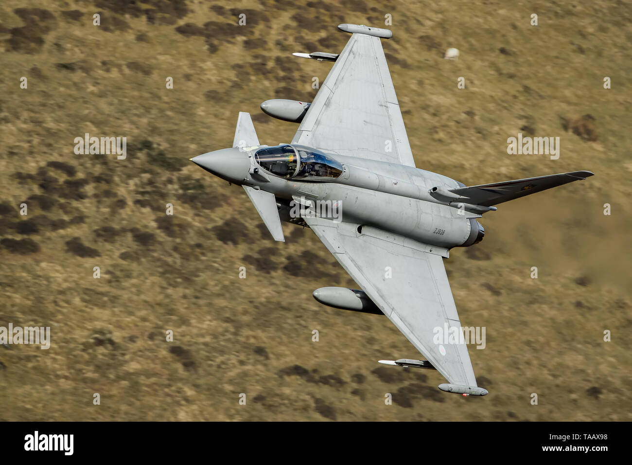 A Eurofighter Typhoon flies through the Mach Loop in Wales, UK Stock Photo