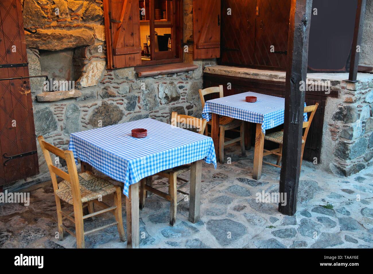 Quaint local restaurant in Moutoulas village in Cyprus. Outdoor tables. Stock Photo
