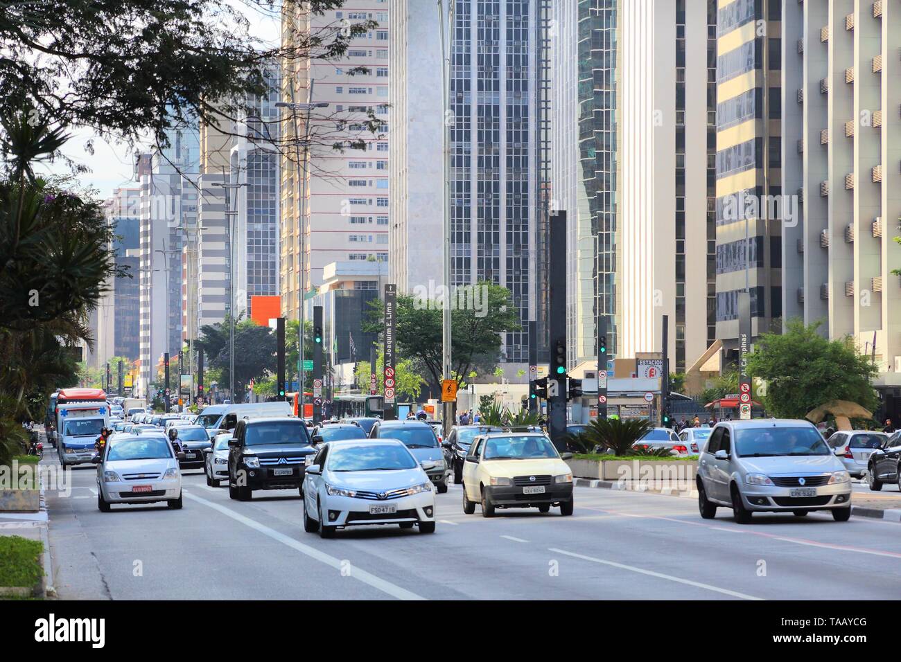 SAO PAULO, BRAZIL - OCTOBER 6, 2014: Cars drive at Avenida Paulista avenue, Sao Paulo. With 21.2 million people Sao Paulo metropolitan area is the 8th Stock Photo