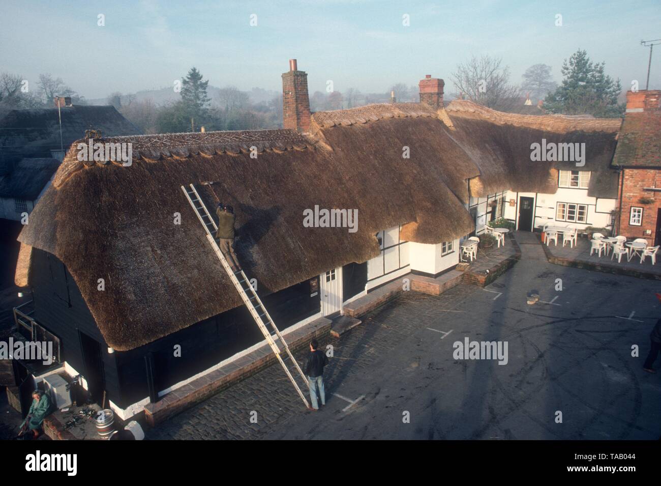 Thatching a village pub, Wiltshire, UK Stock Photo