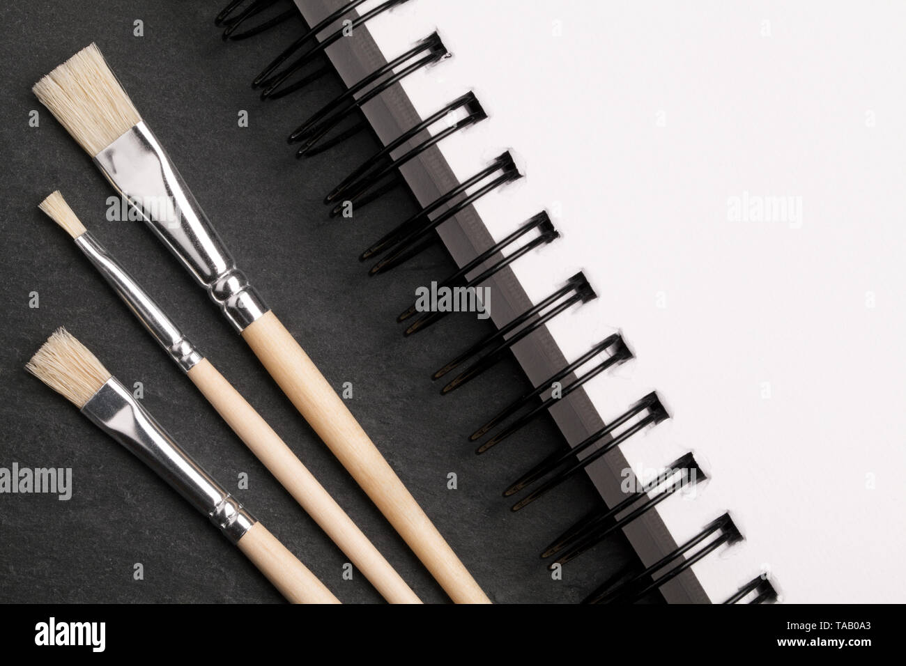 art background with brushes and a notebook Stock Photo
