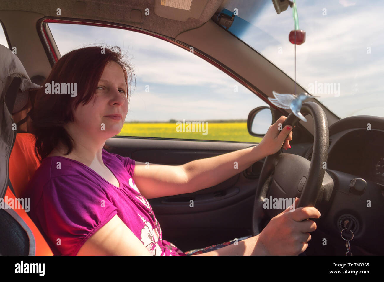 Girl behind steering wheel hi-res stock photography and images - Alamy