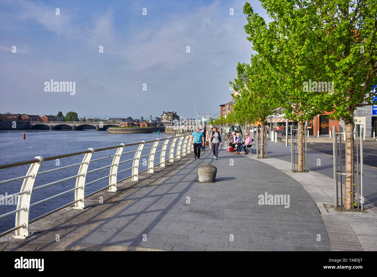 The walkway along the waterfront in Limerick, Ireland with the river