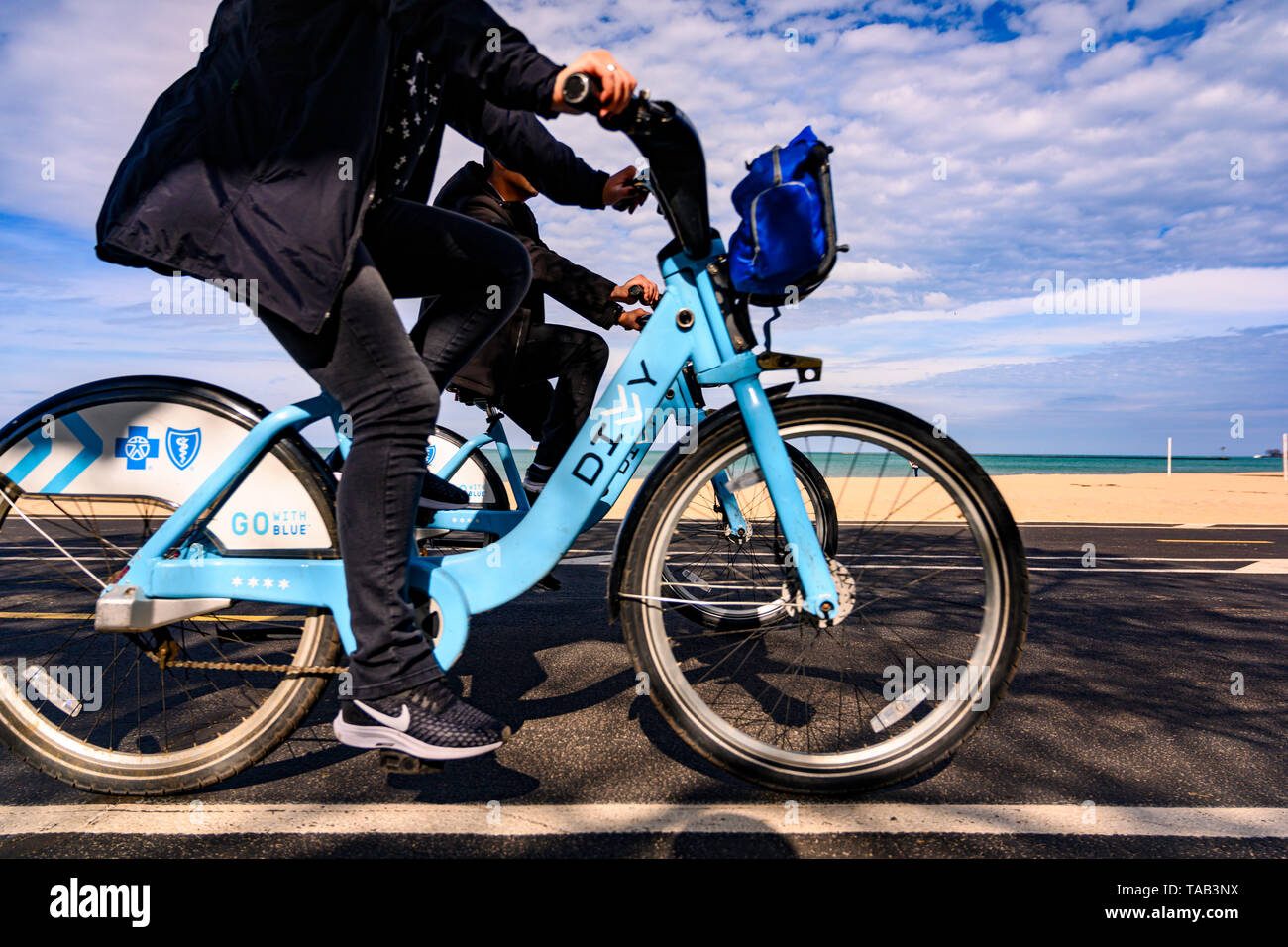 Chicago, IL, United States - May 9, 2019: People riding DIVVY rental bicycles on the lakefront trail near Oak Street Beach. Stock Photo