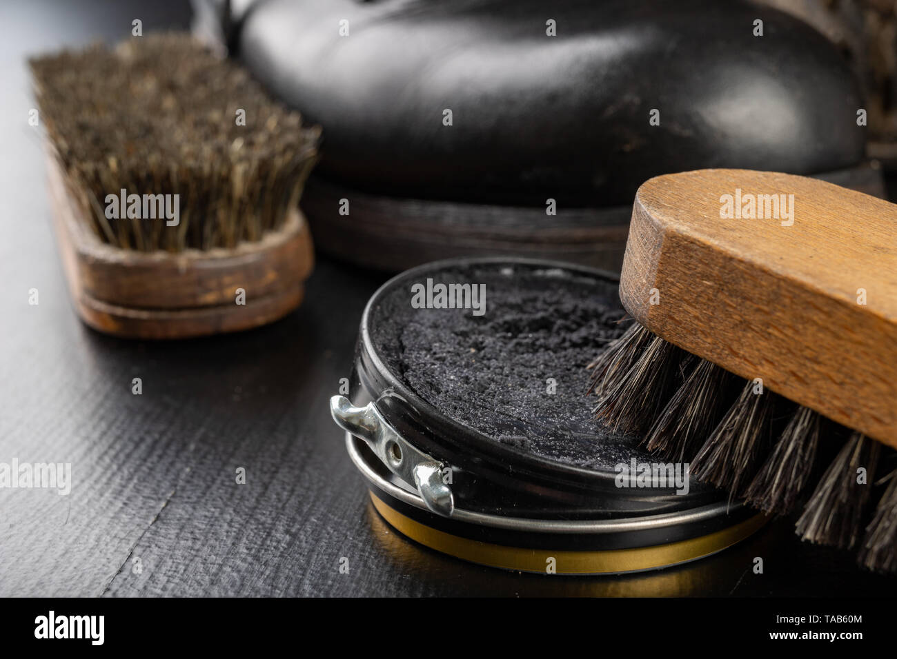 Shoe polish, brush and black military boots. Polishing and cleaning