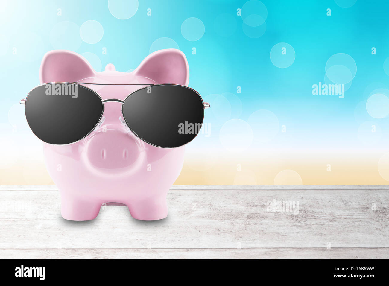 summer piggy bank with sunglasses on the beach Stock Photo - Alamy