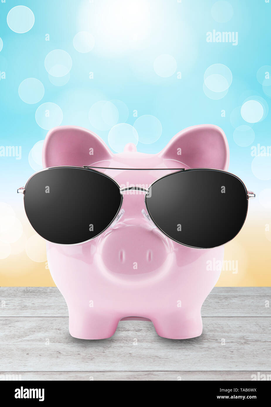 summer piggy bank with sunglasses on the beach Stock Photo - Alamy