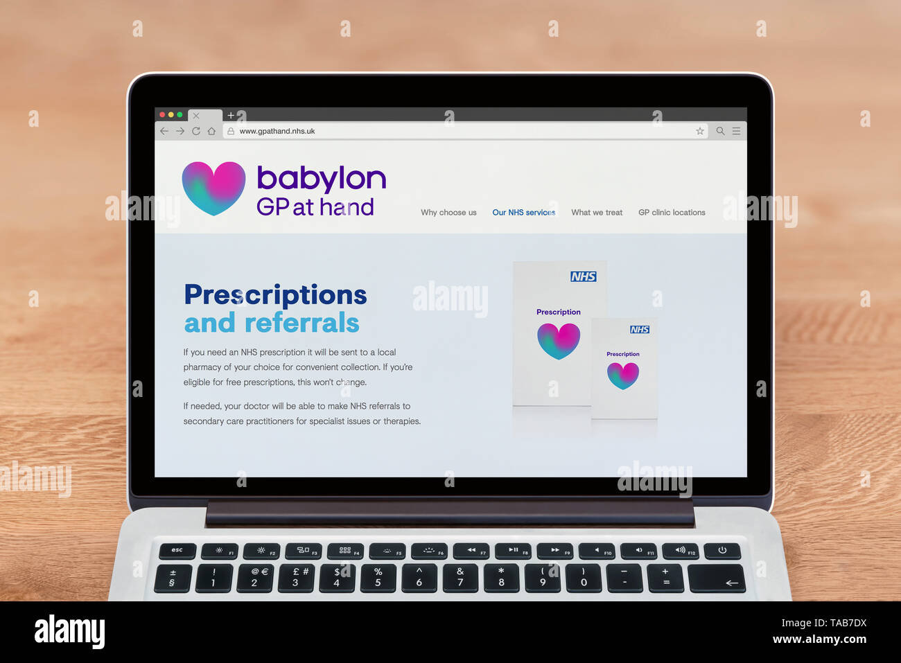 An Apple Macbook displays the Babylon GP at Hand website (Editorial use only). Stock Photo