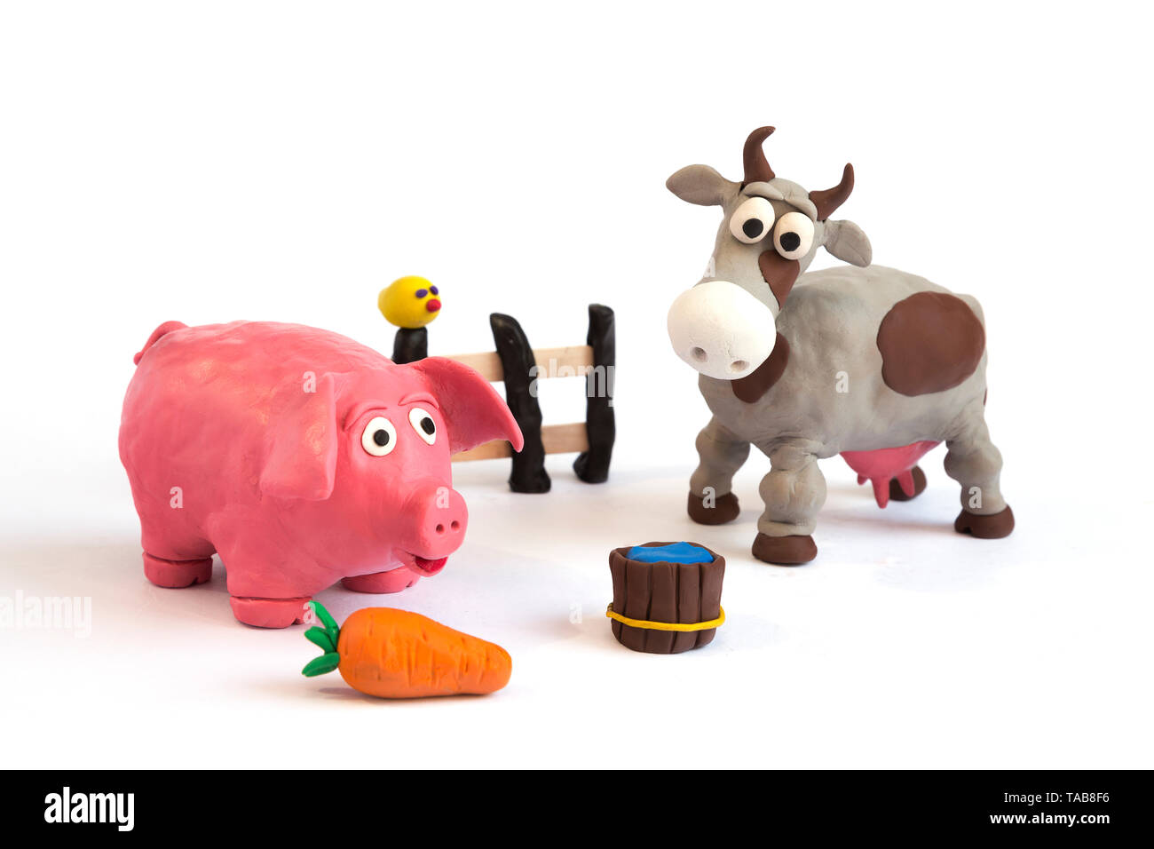 Handmade plasticine clay pig and cow farm Stock Photo