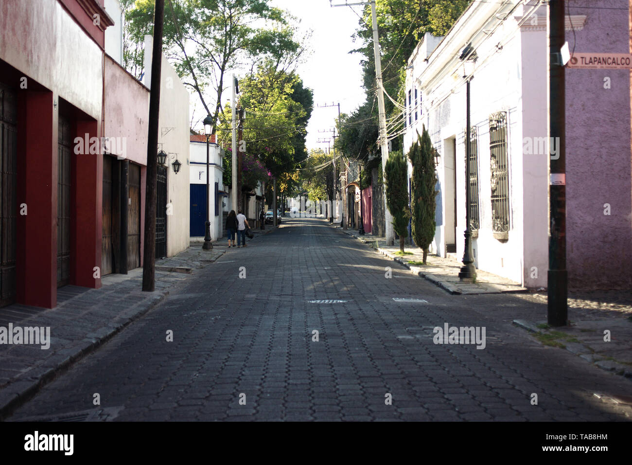 Mexico City, Mexico - 2019: A traditional cobblestone street in the Coyoacan district historic center, a famous touristic neighborhood. Stock Photo