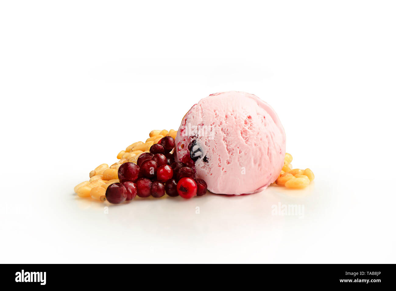 Ice cream ball, cranberries and pine nuts flavor with ingredients, isolated on a white background. Stock Photo