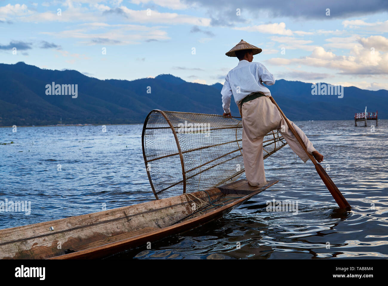 Traditional fisherman with net on boat on Inle Lake, Myanmar. Stock Photo