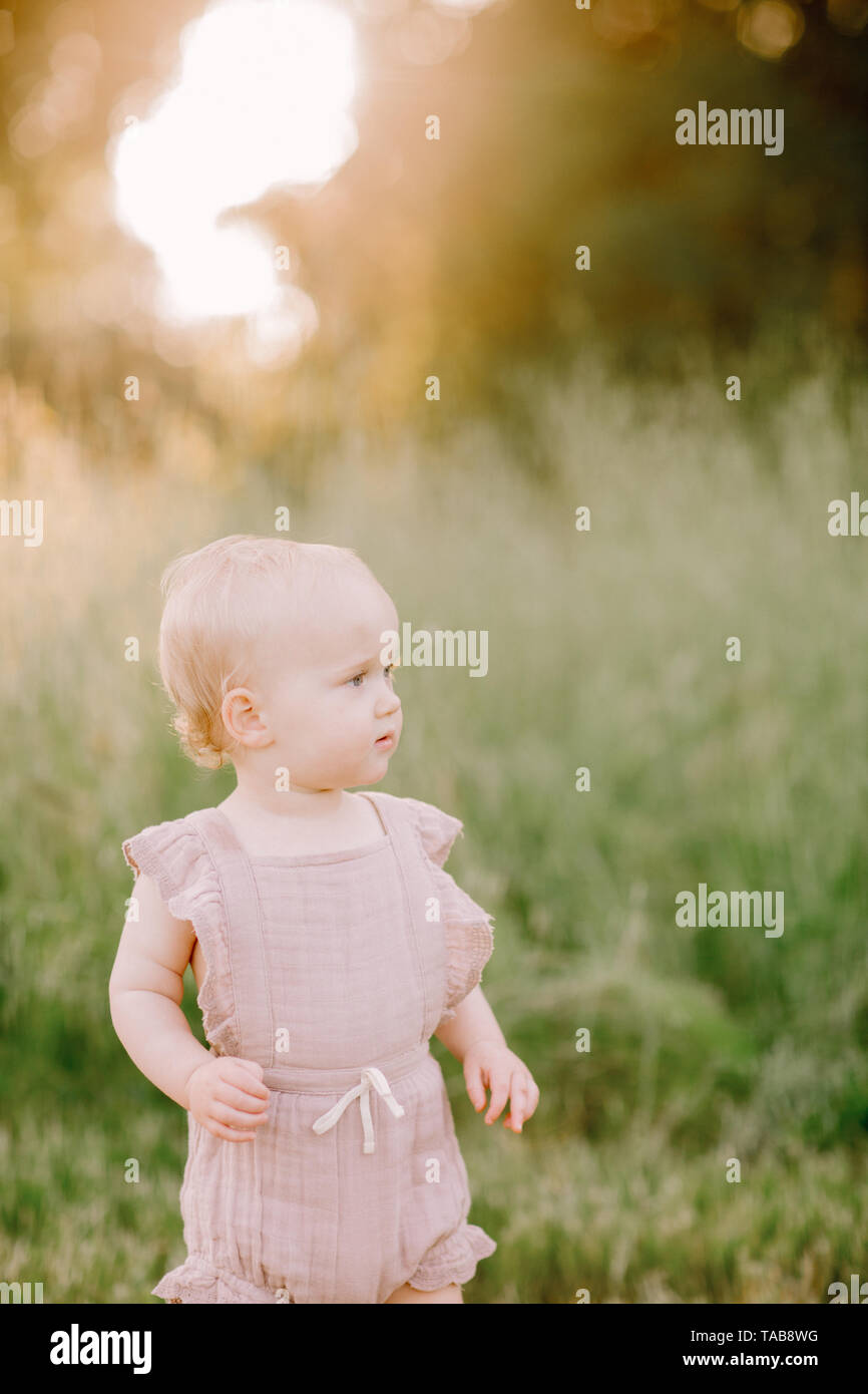 Girl standing in a field hi-res stock photography and images - Alamy